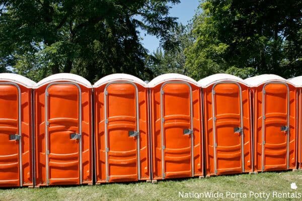 a lineup of clean and well-maintained portable loos for workers in Chetopa, KS